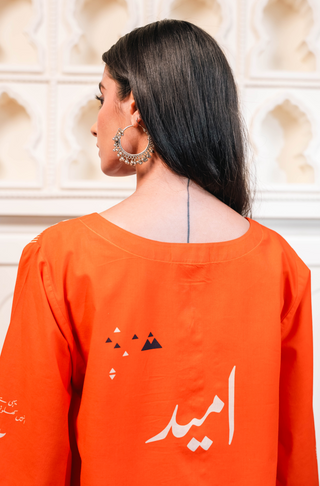 Shopmanto, wear manto, manto clothing brand, manto pakistan, ladies clothing brand, urdu calligraphy clothing, wear manto women ladies lawn kurta for spring summer, manto one piece bright orange umeed kurta with urdu calligraphy for women, spring summer season, lawn collection